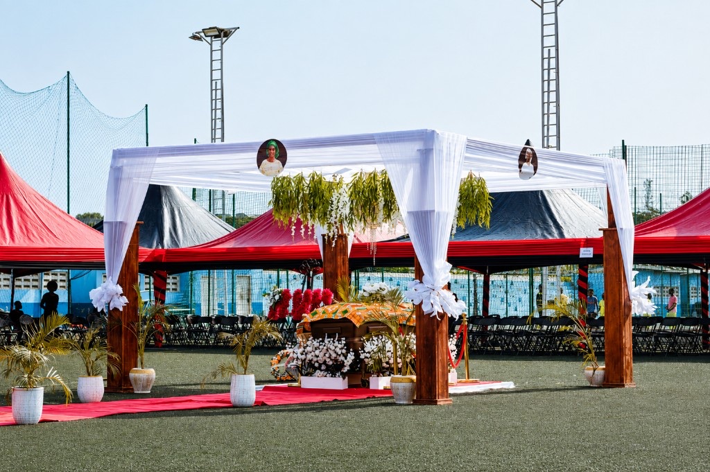 FamilyCare funeral setup with a kente-draped casket